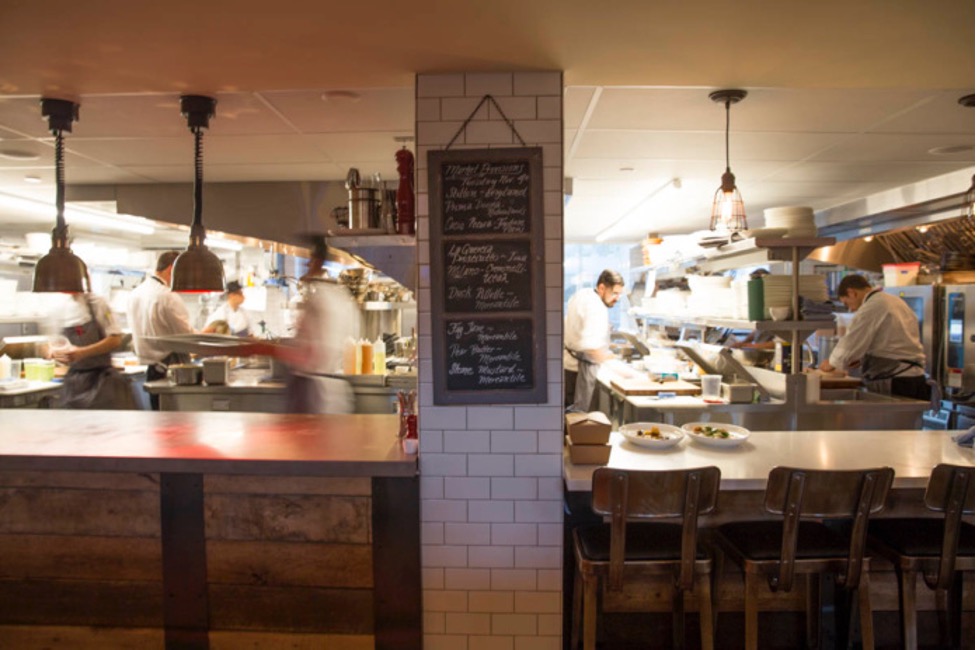 Kitchen and chalkboard menu in a restaurant