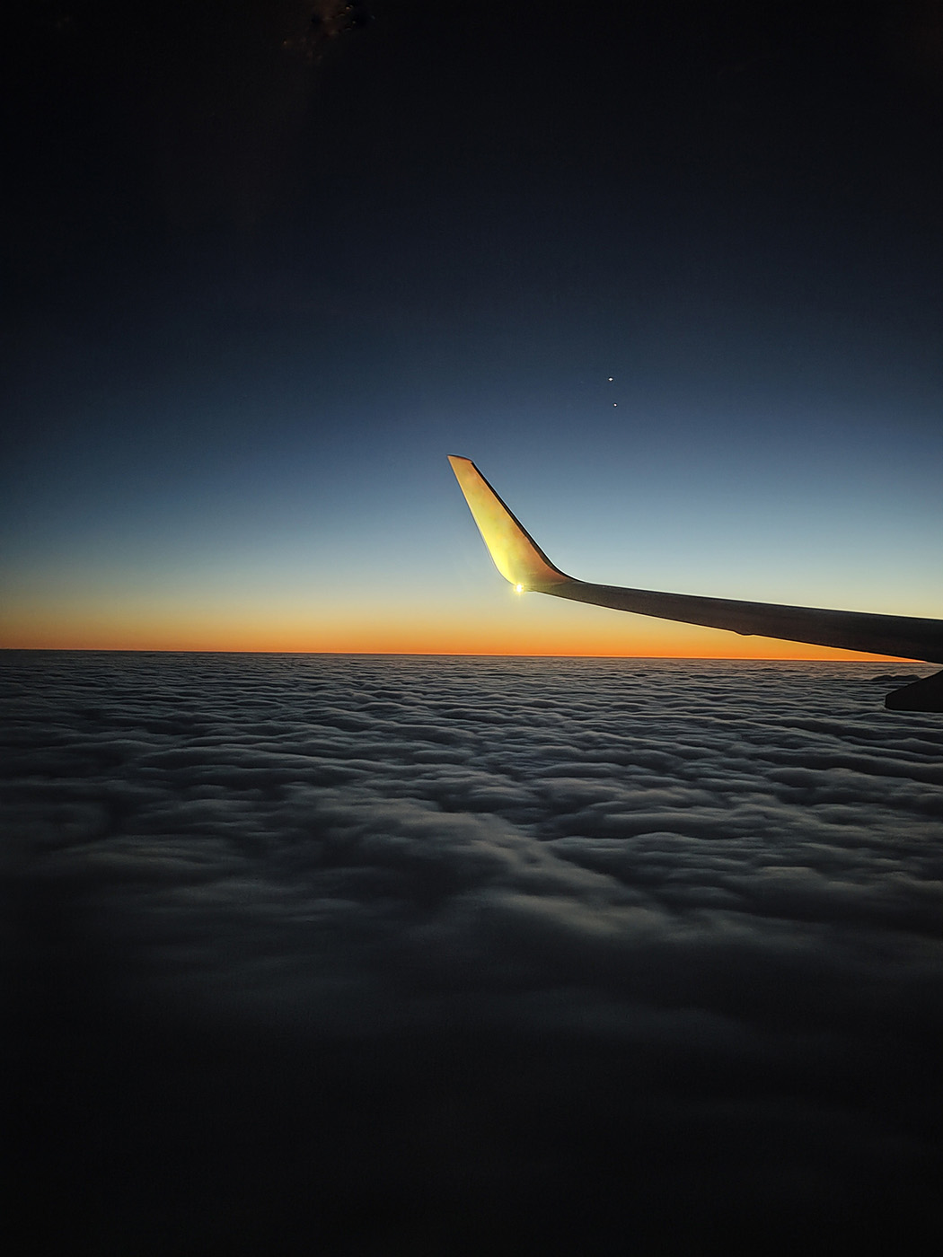 Airplane traveling during the sunset