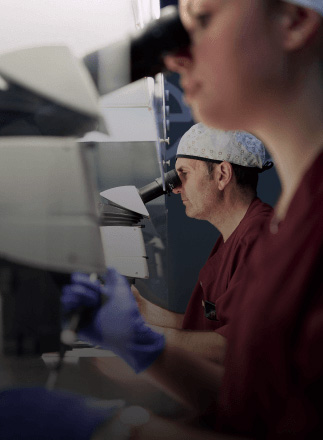 Healthcare workers looking through microscopes