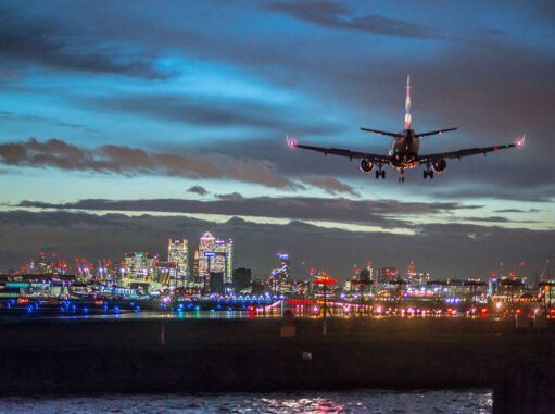 Plane Landing in City at Night