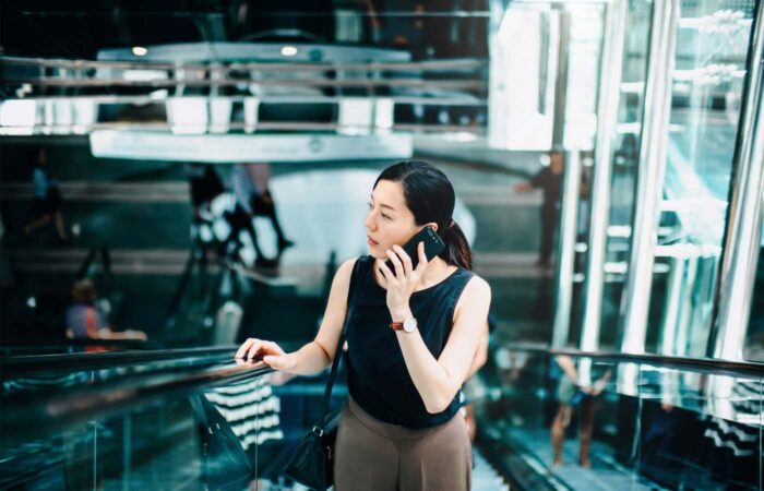 Business woman phone escalator