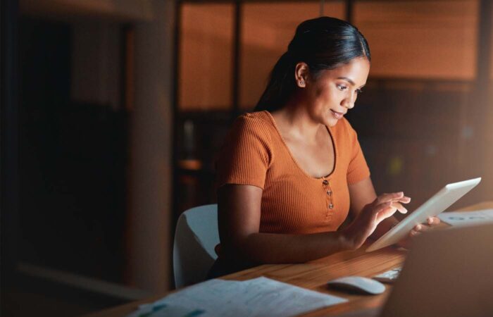 Business professional reviewing performance data on a computer screen for travel program analysis
