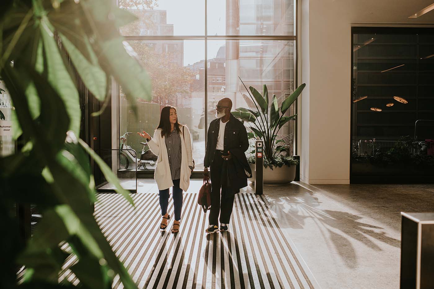 Business professionals arriving at a modern office building before a meeting