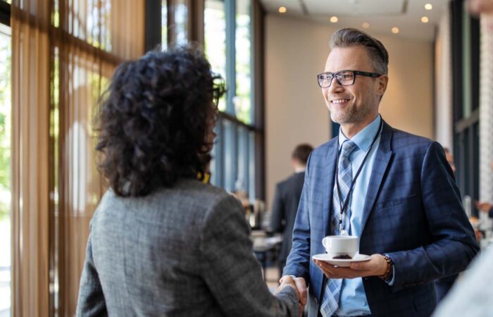 Businessman Discussing During Hotel Coffee Break